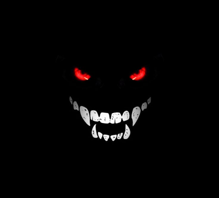 an evil face with glowing red eyes in the dark