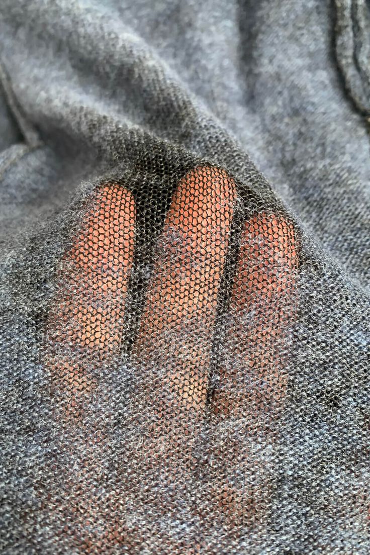 a person's feet are visible through the net on a sweater that is worn by someone