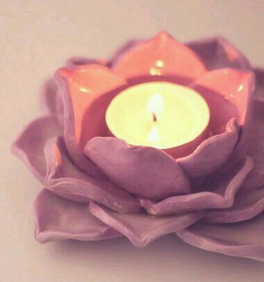 a candle that is sitting on top of a flower