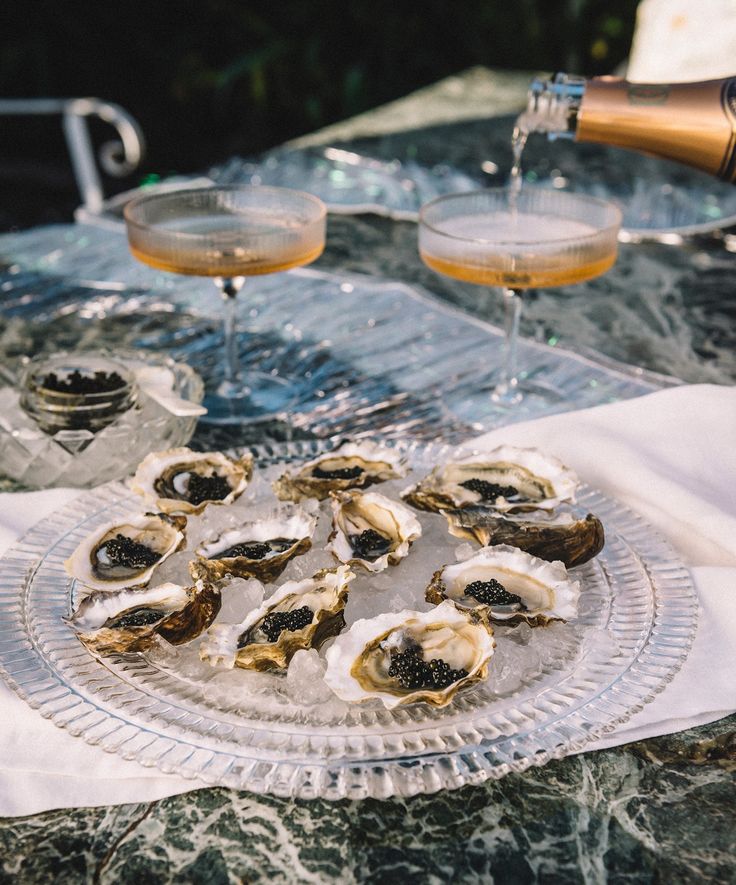 oysters on a plate with champagne being poured