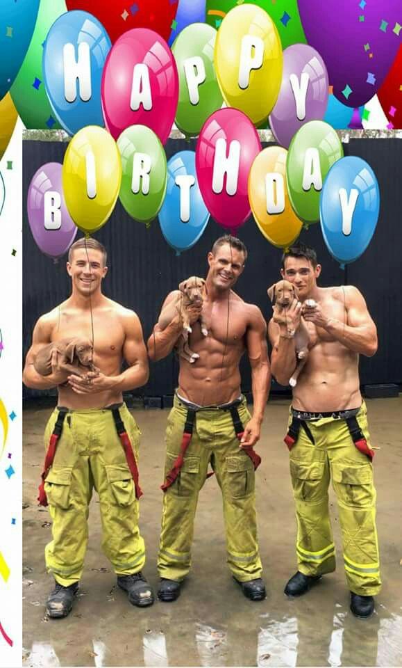 three men in firefighter gear holding puppies and posing for the camera with their hands on their hipss