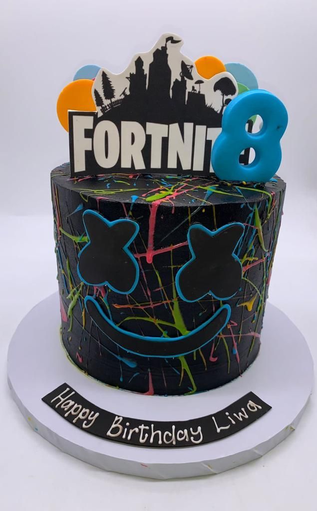 a birthday cake with the number 8 on it's top and graffiti paint splatters