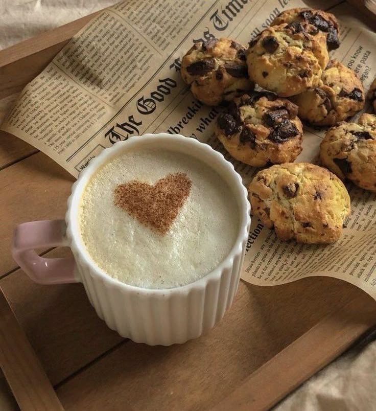 a cup of coffee and some cookies on a tray