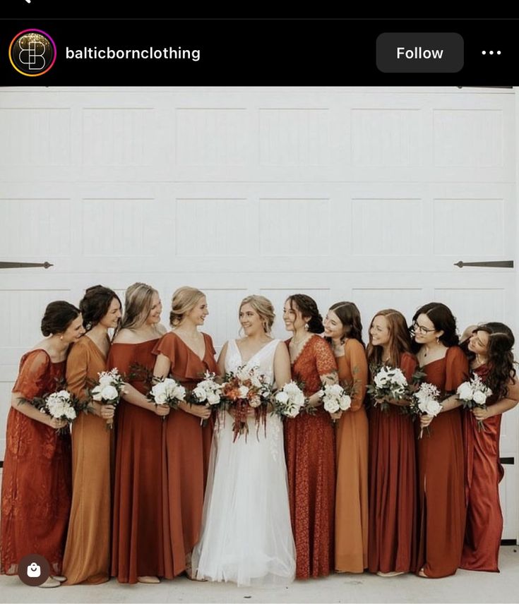 a group of women standing next to each other in front of a white garage door