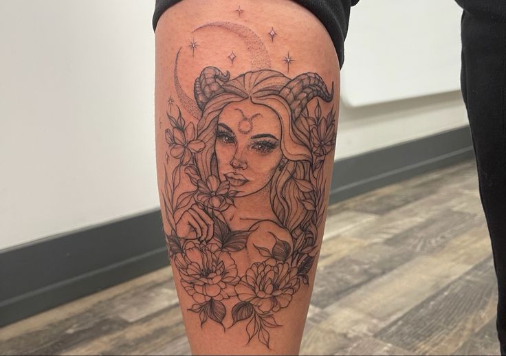 a woman's leg with tattoos on it