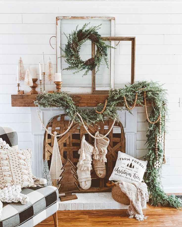 a living room decorated for christmas with stockings hanging from the mantel and wreaths