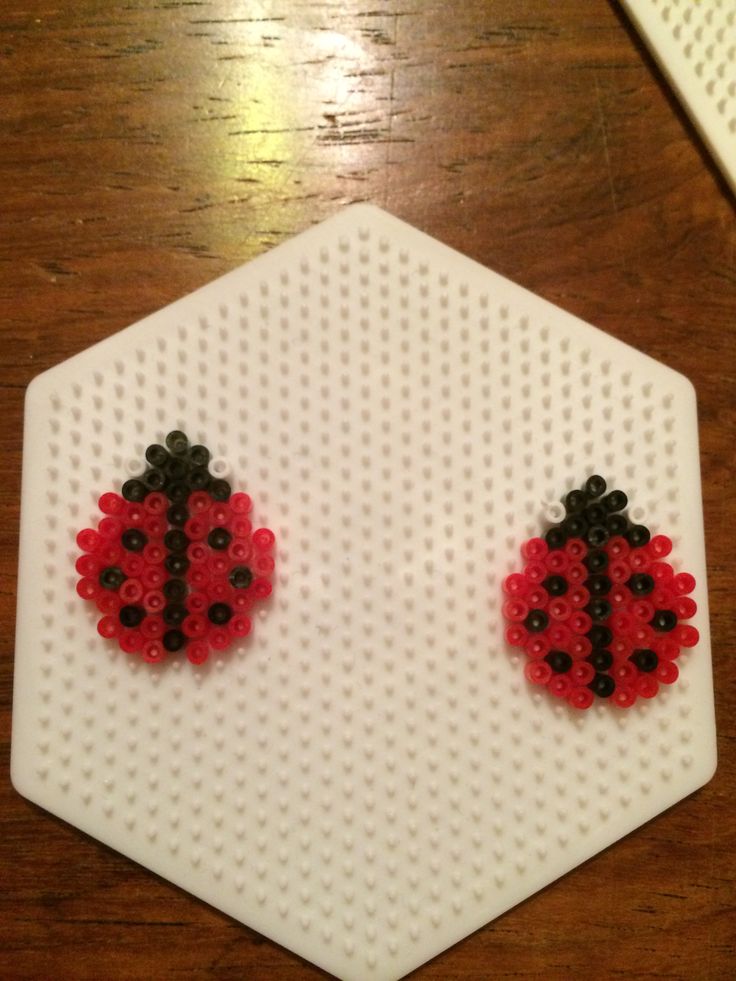 a pair of ladybug earrings made out of legos