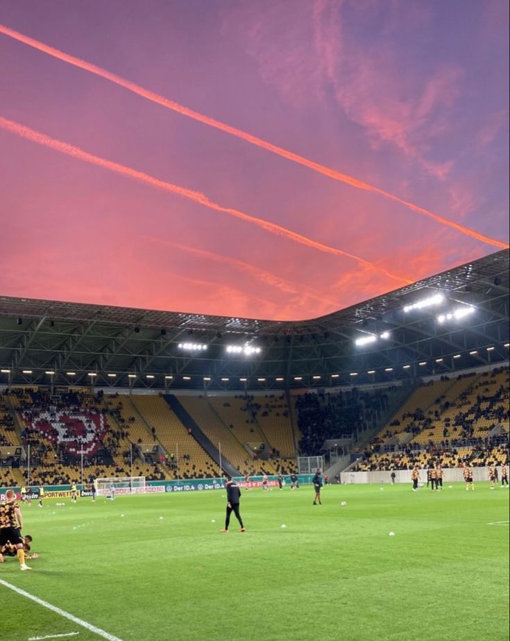 people are playing soccer in an empty stadium