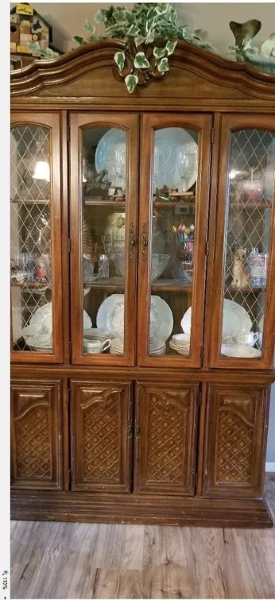 an antique china cabinet with glass doors