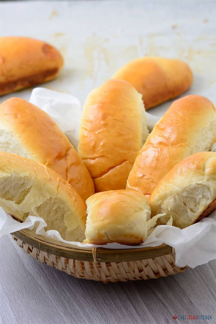 bread rolls in a basket on a table