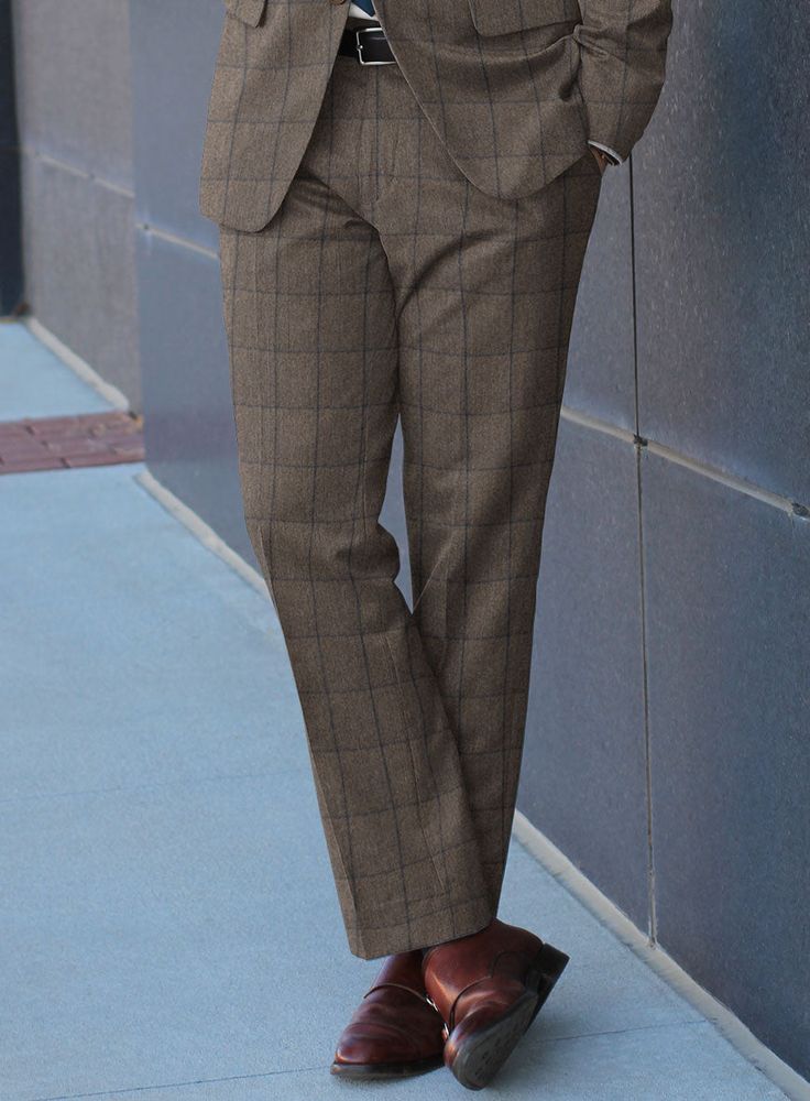 Invent the impeccable signature of style with our Caccioppoli Orenzo Brown Wool Suit. The suit is cut from pure wool fabric to serve a plush, warm, and cozy texture, casting a distinctive touch of class with the stunning checks pattern over a brown tone. Also, the traditional heritage brings an opulent depth to the posture without sacrificing a bit of comfort to accompany you from formal events to adventurous excursions. 
 
 Look Includes  Caccioppoli Orenzo Brown Wool Fabric  Two Button Jacket Formal Brown Wool Bottoms, Classic Brown Wool Pants, Brown Wool Formal Pants, Brown Single-breasted Wool Suit, Mens Brown Houndstooth Pants, Grey Tweed Suit, Green Velvet Jacket, Herringbone Tweed Jacket, White Linen Suit