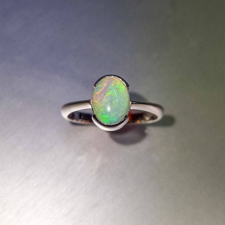 Coober Pedy solid crystal opal, half bezel set in a sterling silver ring. Opal  Weight: 1.1ct Size: 9x7mm Ring size AUS: O1/2 US: 7 3/4 Band diameter: 17.8mm Band width: 1.6-2.4mm tapered Materials: Solid opal, sterling silver Total weight: 2.3gm Opal Silver Ring, Half Bezel Setting, Half Bezel, Opal Band, Coober Pedy, Ring Opal, Crystal Opal, Opal Crystal, Black Opal