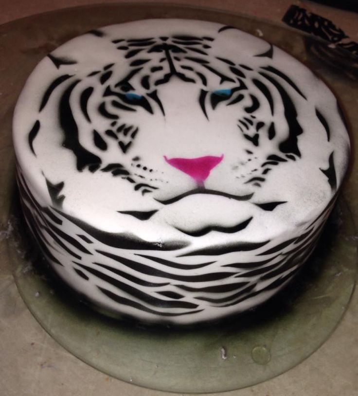 a white tiger cake with black and pink icing