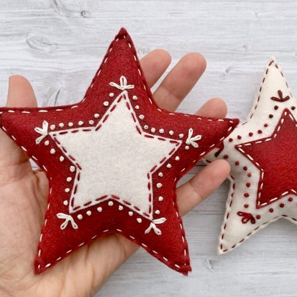 two red and white stars are held in their hands