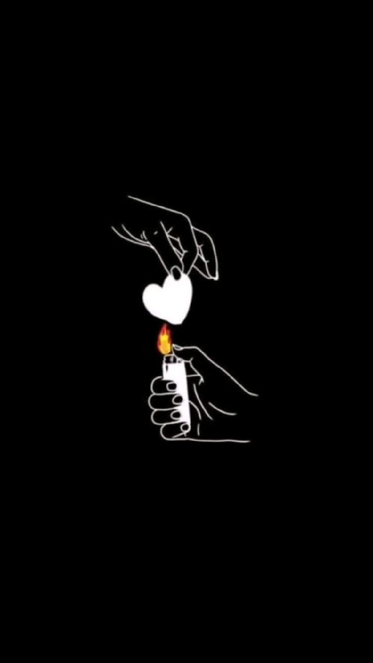 a hand holding a lit candle in the middle of a black background with white writing on it