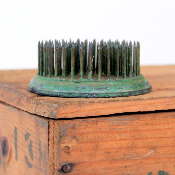 a wooden box with a green brush on top of it