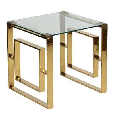 a glass and gold end table with metal legs