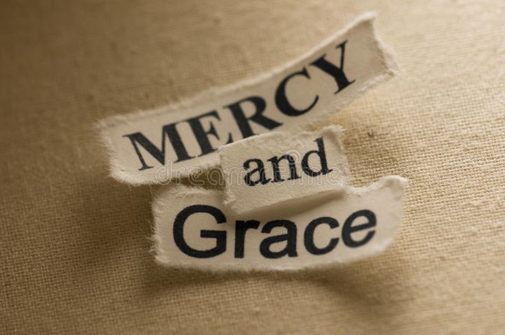 a piece of torn paper with the words mercy and grace on it