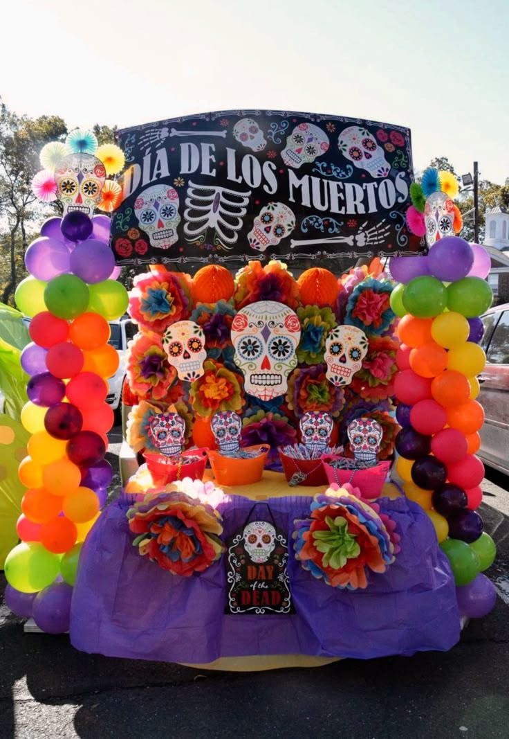 a car decorated with balloons and decorations for a day of the dead celebration