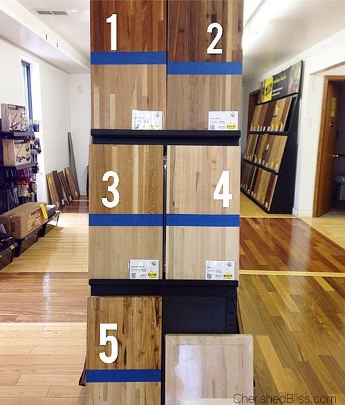 there are many different types of flooring in the store with numbers on each shelf