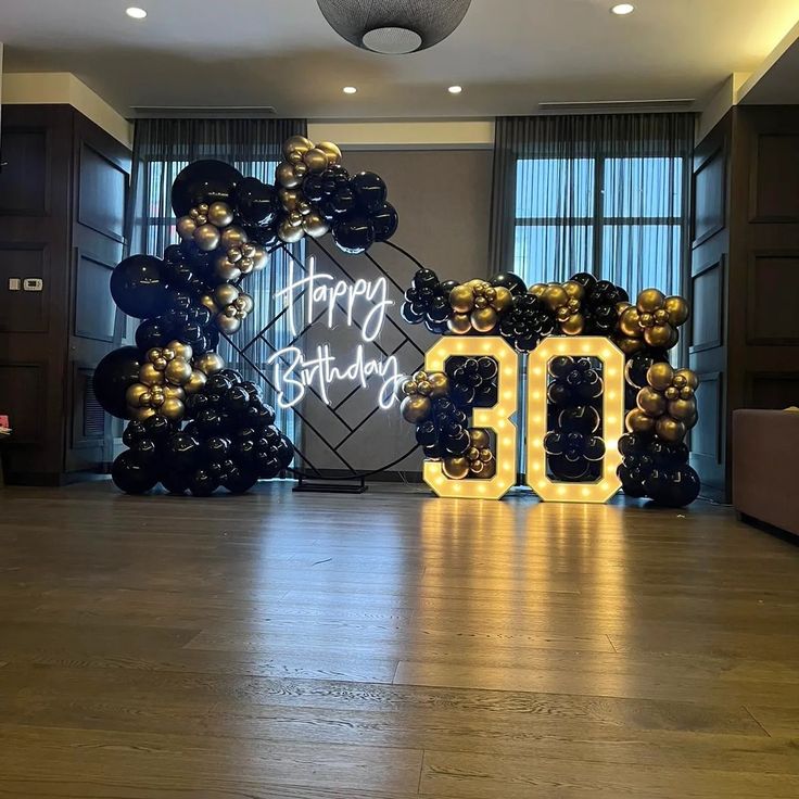 Black/Gold Balloon garland with a 30 Marquee sign 30th Birthday Balloons Decoration Men, Black And Gold 50th Birthday Backdrop, 75th Birthday Centerpieces Ideas For Men, Decoration For Men's Birthday, 30th Birthday Parties Men, 35th Birthday Backdrop Ideas, 30th Birthday Backdrop For Men, Men Black And Gold Party Ideas, Gold And Black Balloons Decoration