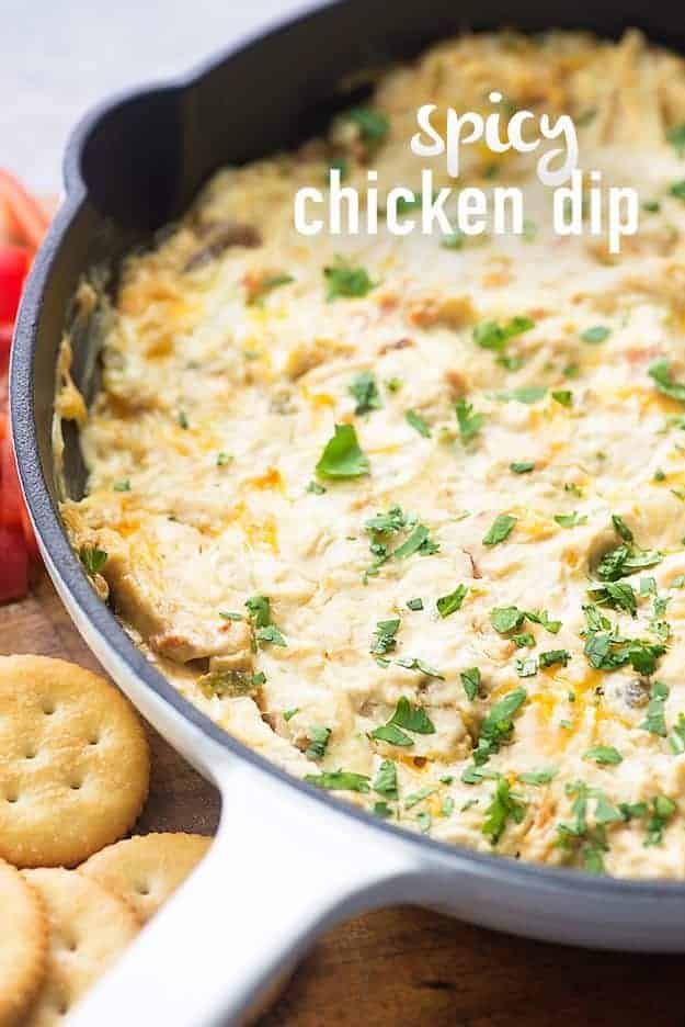 a casserole dish with chicken dip and crackers