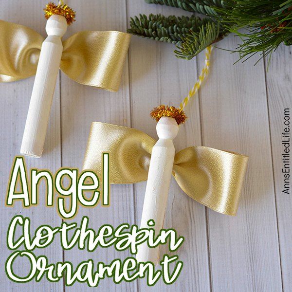 an angel ornament made out of toilet paper rolls and twine with gold bows