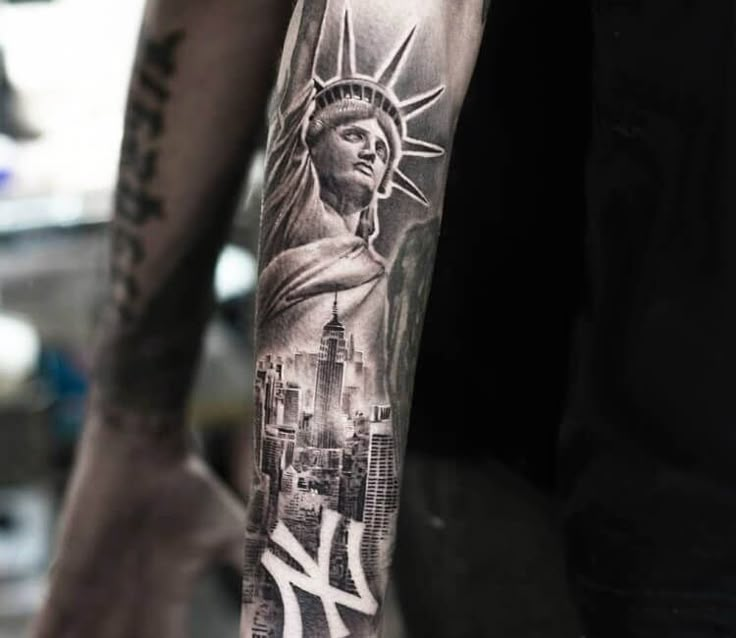 a man's arm with a statue of liberty tattoo on it