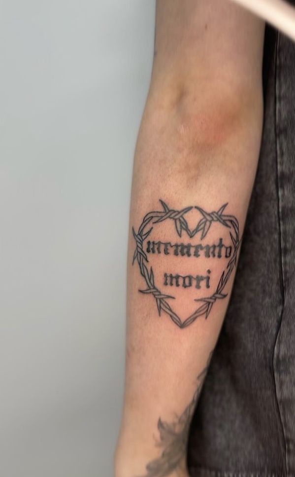 a man with a tattoo on his arm that says, strength is more than love