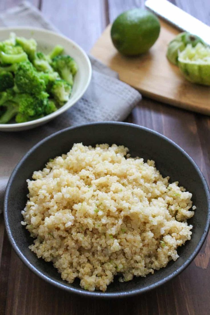 rice and broccoli in a bowl on a wooden table next to a cutting board