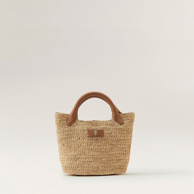 Cassia Mini Eco-friendly Handheld Straw Beach Bag, Eco-friendly Handheld Straw Bag With Leather Handles, Eco-friendly Woven Straw Bag With Top Handle, Eco-friendly Woven Leather Straw Basket Bag, Eco-friendly Straw Basket Bag With Braided Handles, Evening Accessories, Natural Tan, Basket Bag, Embossed Logo