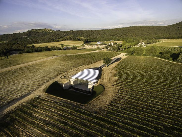 an aerial view of a farm with a covered structure in the middle