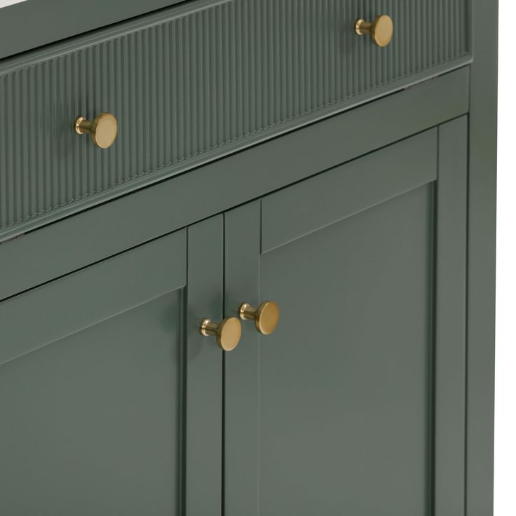 a green cabinet with brass handles and knobs on the doors is shown in this image