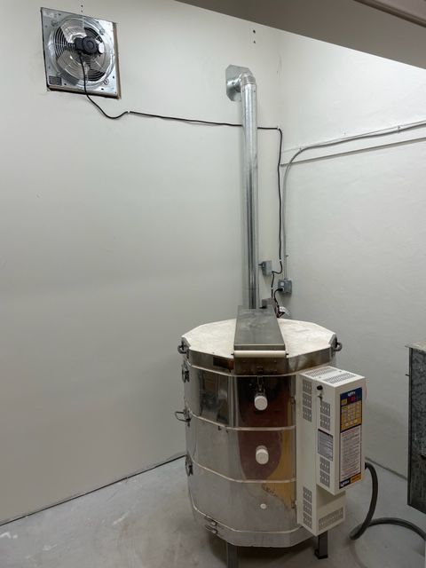 a large metal tank sitting inside of a room next to a wall mounted heater