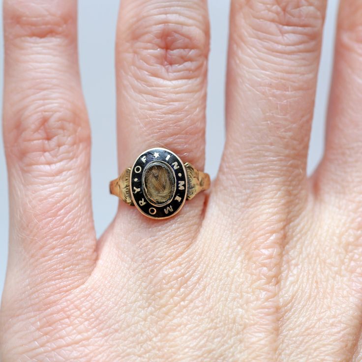 "Exquisite 10k gold and black enamel Victorian hair locket mourning ring. Ring face measures 12mm x 9.5mm and the words \"IN MEMORY OF\" encircle the memento locket. The enamel has been impeccably preserved. Ring size 3.24. Sizing available Layaway available" Heirloom Engraved Oval Enamel Ring, Heirloom Oval Engraved Enamel Ring, Victorian Enamel Ring Engraved For Anniversary, Victorian Engraved Enamel Ring For Anniversary, Heirloom Style Hallmarked Engraved Ring For Memorial, Heirloom Style Signet Ring With Black Enamel As Gift, Antique Signet Ring With Black Enamel For Gift, Antique Yellow Gold Signet Ring With Black Enamel, Antique Black Enamel Signet Ring As Gift