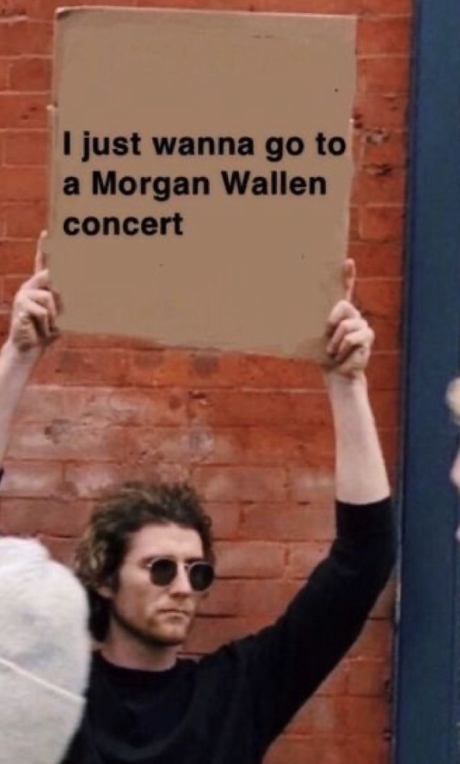 a man holding up a sign that says i just wanna to be a morgan wallen concert