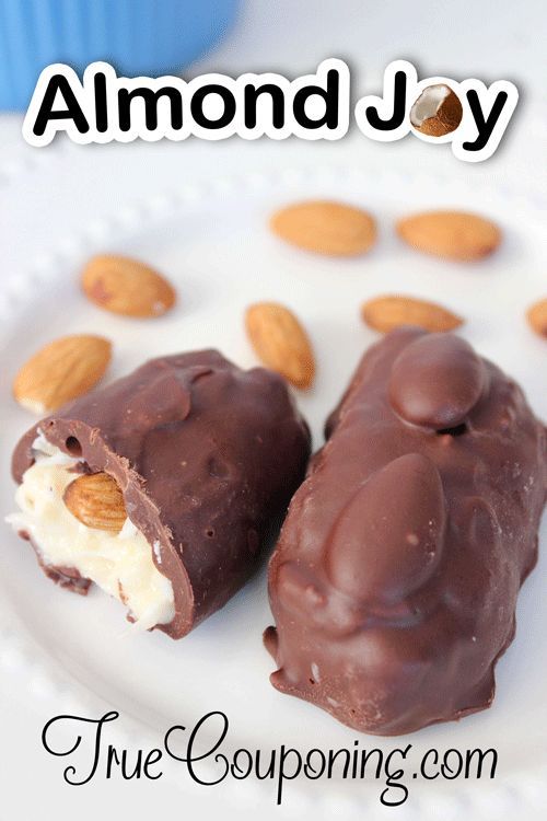 two chocolate covered desserts on a plate with almonds around them and the words almond joy above it