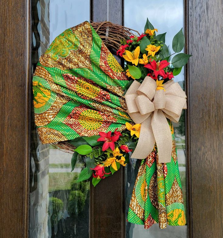 a wreath on the front door decorated with flowers