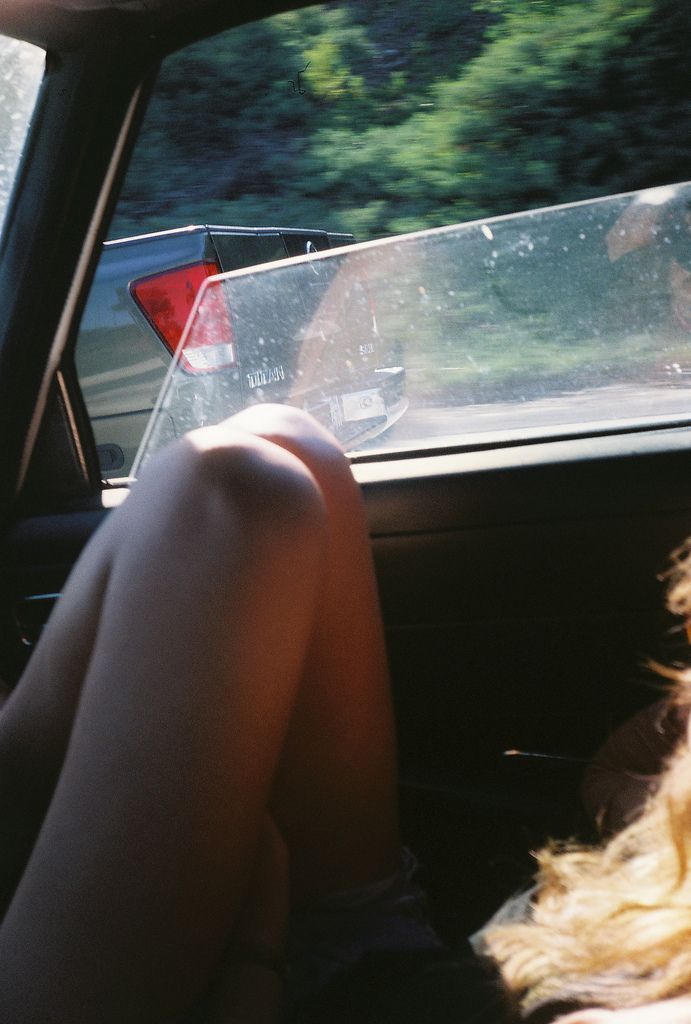 a woman sitting in the back seat of a car