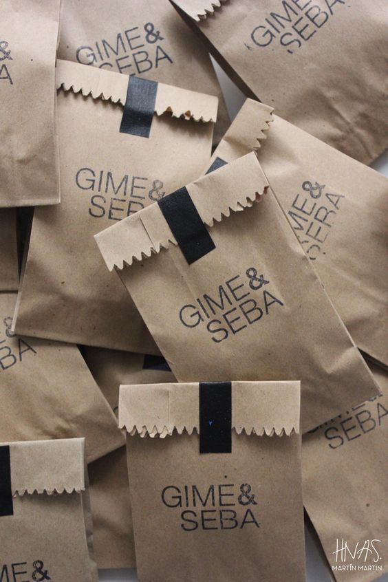 some brown paper bags with black and white labels on them that say gime & seba