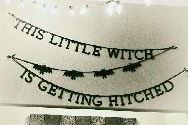 this little witch is getting hitched sign hanging on the wall in front of a fireplace