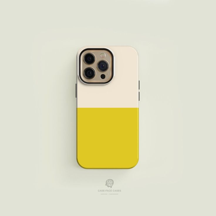 a yellow and white iphone case sitting on top of a table