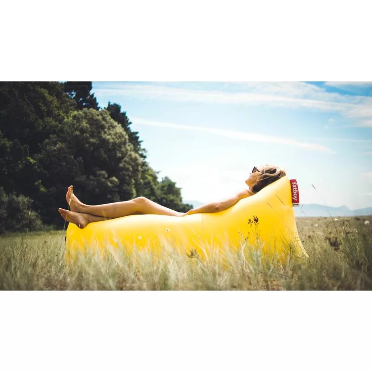 a woman laying on top of an inflatable banana