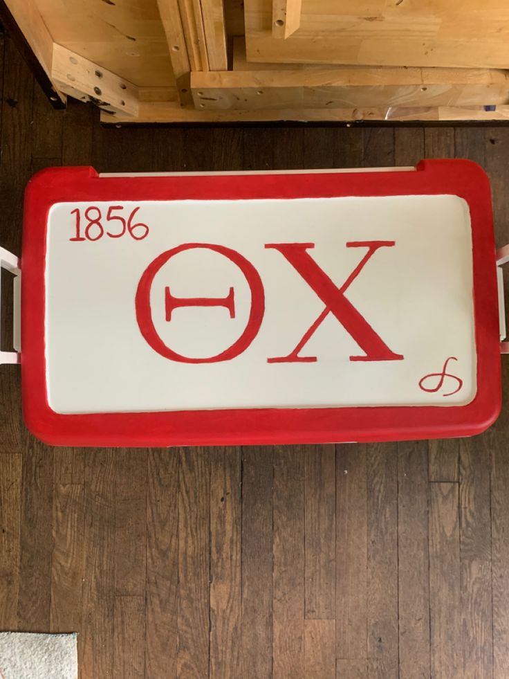 a red and white sign with the word fox on it's side hanging from a wooden ceiling