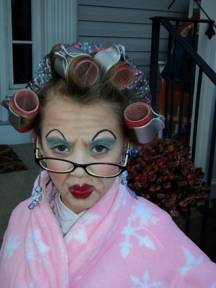 a woman with curlers on her head and glasses