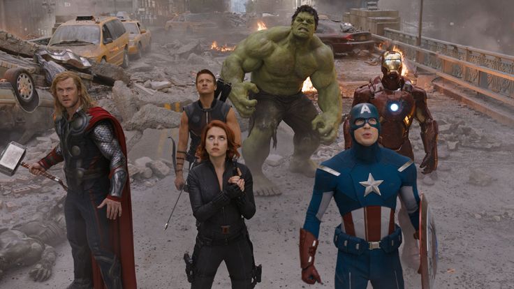 the avengers movie is being shown in this screenshot with many people standing around and looking at them