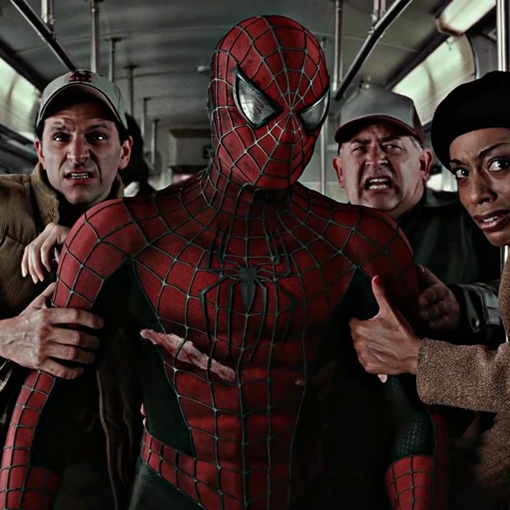 the amazing spider - man and his gang on a subway car with their arms around each other