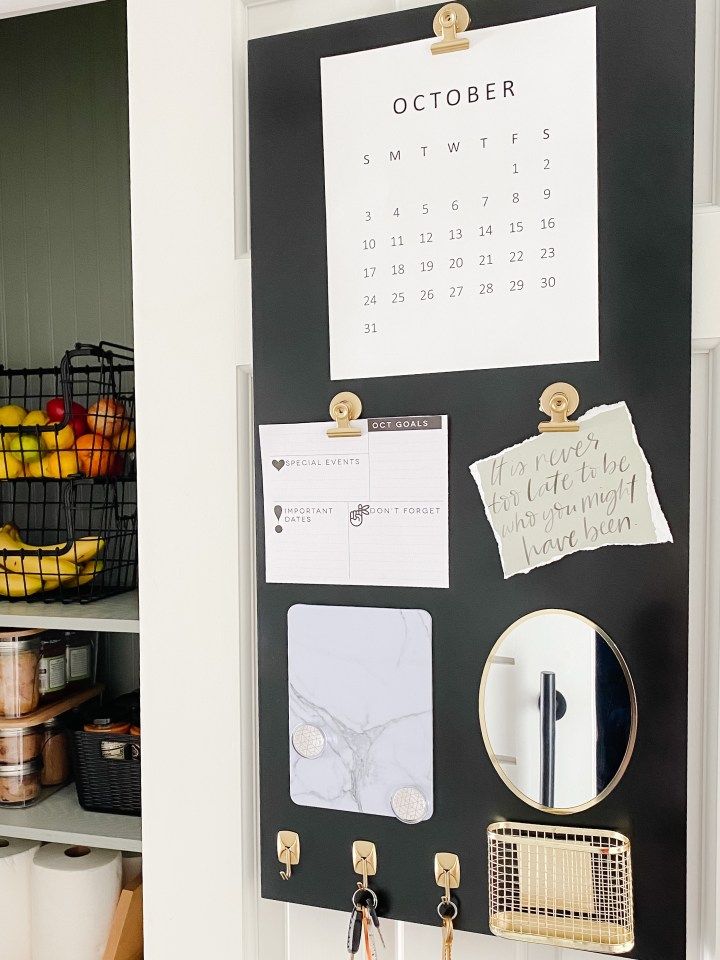 a black and white calendar hangs on the wall next to a shelf filled with other items