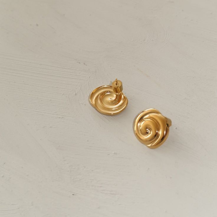 Our Billow design in mini form. The perfect daily earring. Lightweight and hollow back. Materials & Specifications stainless steel 18K Gold Plating19x17 mm circumference Elegant Spiral Gold Plated Earrings, Gold Polished Clip-on Earrings For Gift, Gold Plated Clip-on Earrings With Polished Finish, Gold Clip-on Earrings With Polished Finish As Gift, Modern Gold Plated Tarnish Resistant Clip-on Earrings, Modern Yellow Gold Plug Earrings, Modern Spiral Earrings For Formal Occasions, Modern Yellow Gold Clip-on Earrings, Yellow Gold Spiral Single Earring