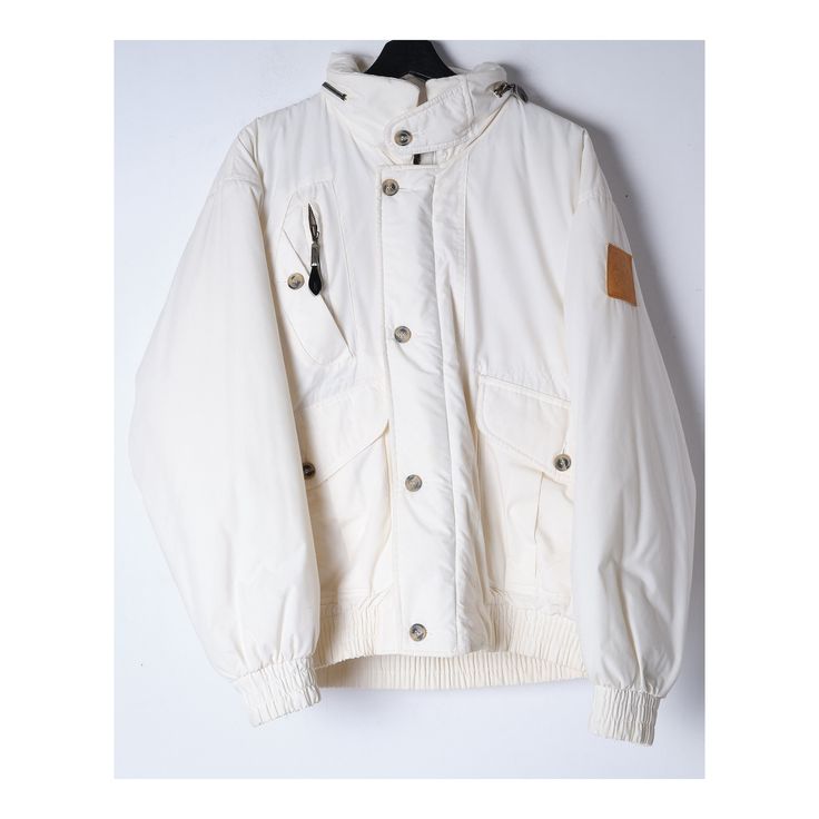 Gorgeous unisex bomber jacket in cream-white color.  The hood is hidden in the neck collar, chiclet buttons, slanted pockets, and brand badge on the left arm.   Size: men's S / wmns M   shoulders bust  sleeve (from armpit)  length  era: 2000s/y2k  content: cotton/polyester condition: excellent color: white cream  brand: Artic Circle  - Fast free shipping via Global Express to the United States, Canada, Australia, Austria, Belgium, China, Czech Republic, Denmark, Estonia, Finland, Germany, Greece, Hungary, Ireland, Israel, Japan,  Latvia, Lithuania, the Netherlands, Norway, Romania, Slovakia, South Korea, Sweden, Switzerland, the United Kingdom.  - Rest of the world free shipping via priority Polish Post - Domestic - InPost VISIT OUR SHOP FOR MORE NEW LISTINGS AND STUFF! https://www.etsy.co White Windbreaker For Winter Streetwear, Casual Beige Puffer Jacket For Streetwear, White Windbreaker With Ribbed Cuffs For Fall, White Hooded Puffer Jacket For Streetwear, White Hooded Jacket With Detachable Hood For Streetwear, White Outerwear With Detachable Hood For Streetwear, White Hooded Jacket With Ribbed Cuffs For Winter, Casual Winter White Puffer Jacket For Streetwear, Casual White Puffer Jacket For Streetwear